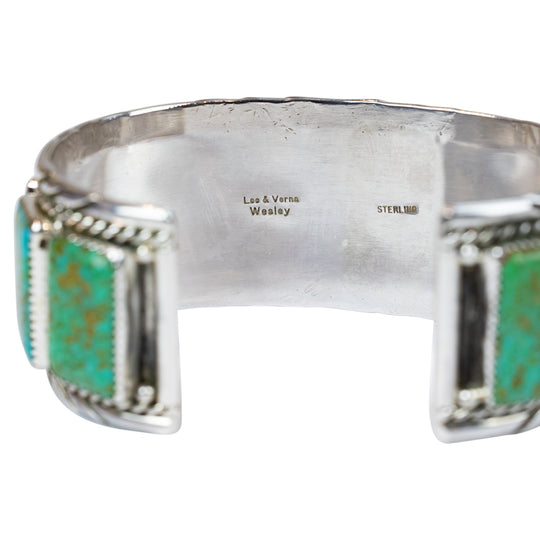 Silver bracelet with turquoise stones on a white background