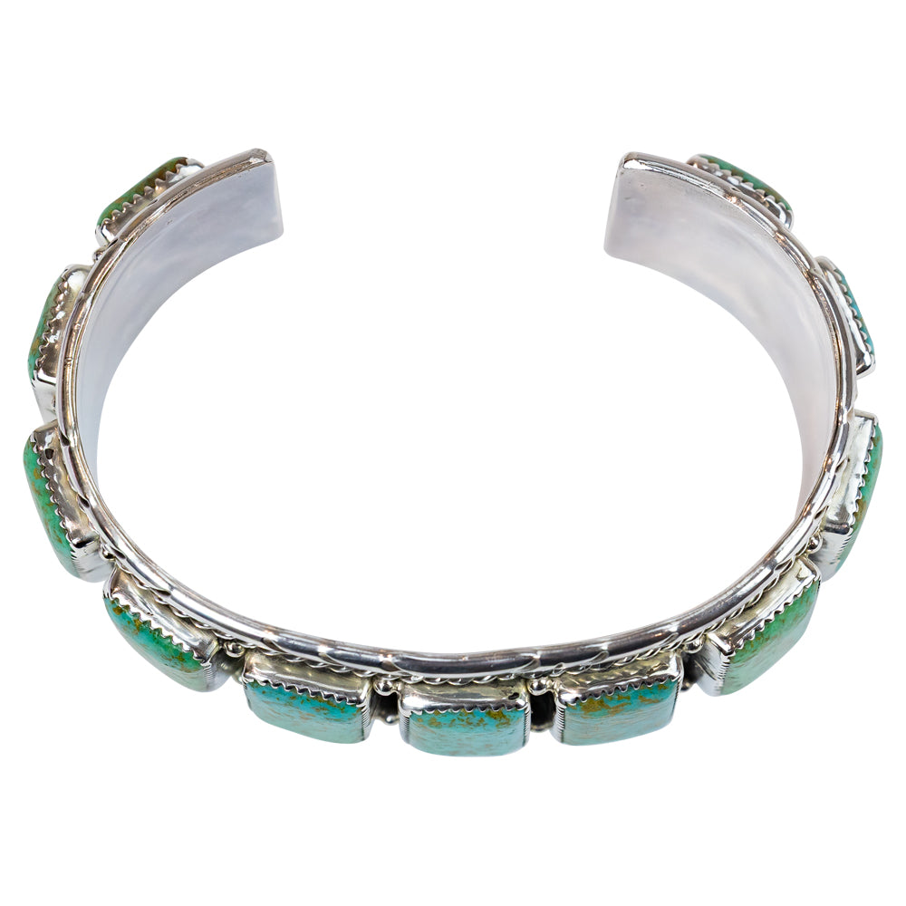 Silver bracelet with turquoise stones on a white background
