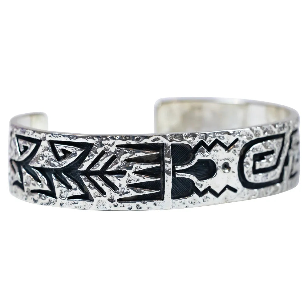 Silver bracelet with black tribal designs on a white background