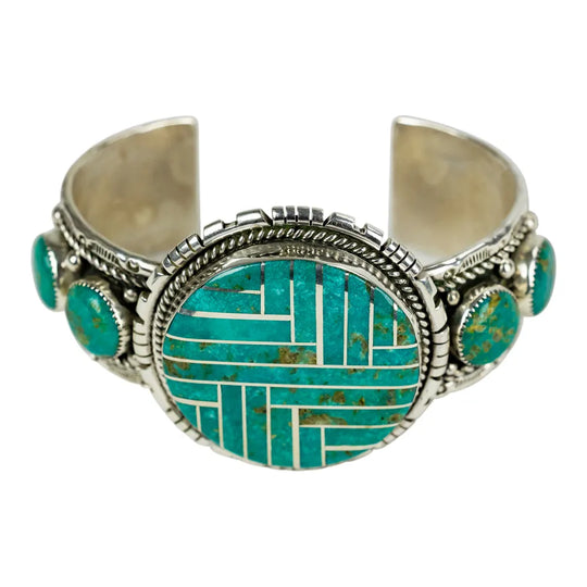 Silver and turquoise Navajo bracelet on a white background