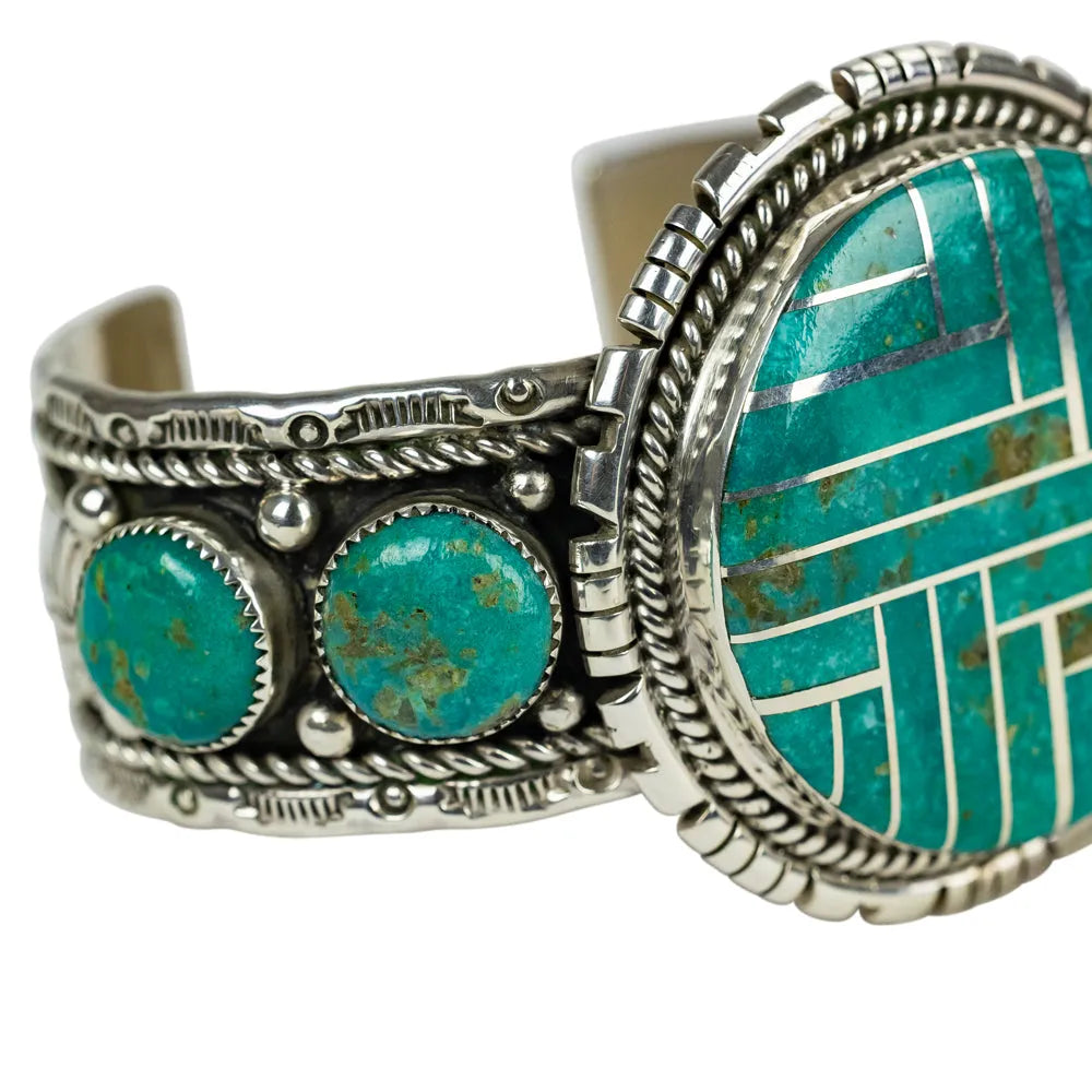 Turquoise and silver bracelet on a white background