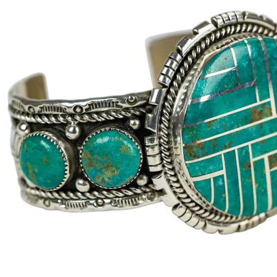 Turquoise and silver bracelet on a white background