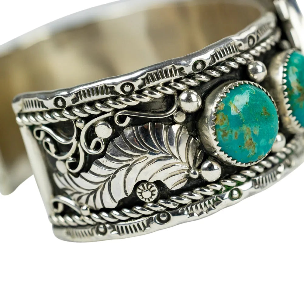 Silver bracelet with turquoise stones on a white background