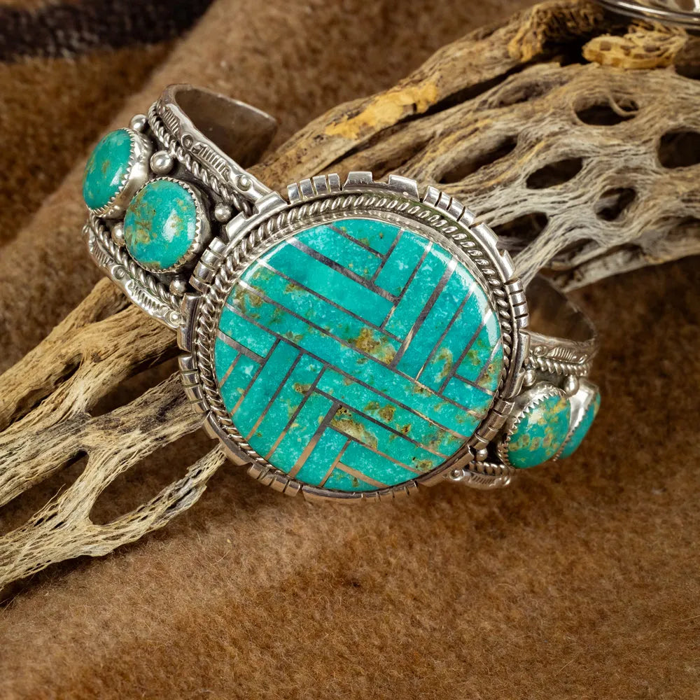 Turquoise and silver ring on a natural wood background
