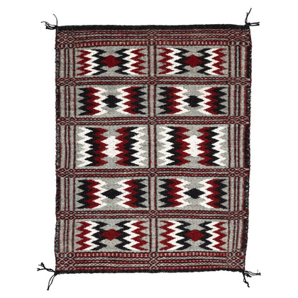 Side one of Two-Faced Navajo Rug by Rosebelle Nez on white background.