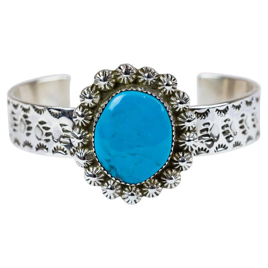 Silver bracelet with a turquoise stone on a white background