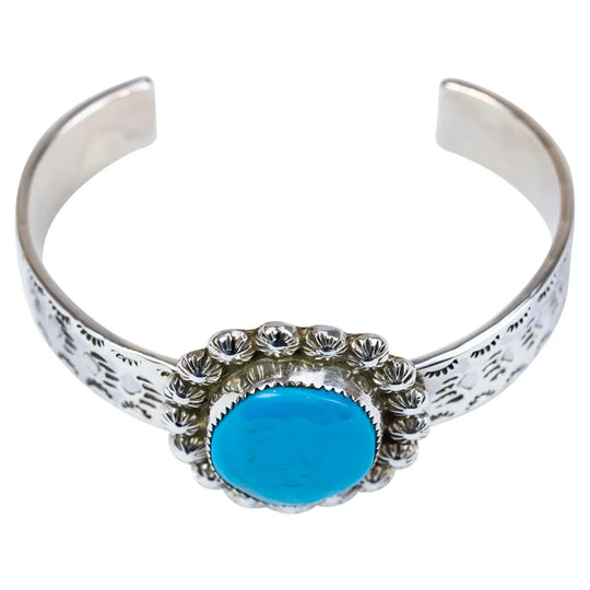 Silver bracelet with a turquoise stone on a white background