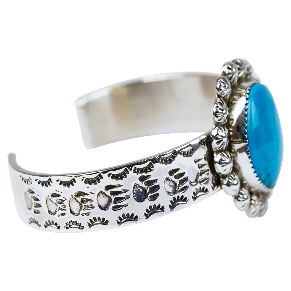Silver bracelet with turquoise stone on a white background