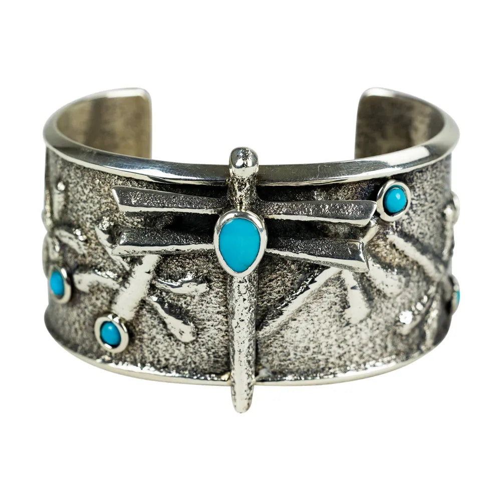Silver Navajo cuff bracelet with turquoise stones on a white background