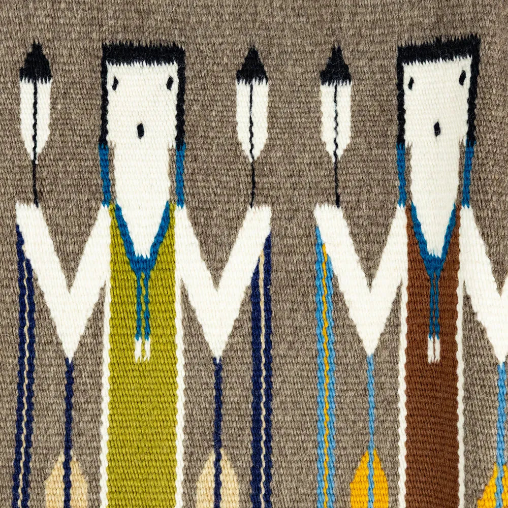 Handwoven wool textile with stylized Yei figures on a brown background