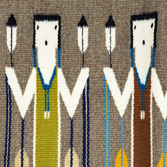 Handwoven wool textile with stylized Yei figures on a brown background