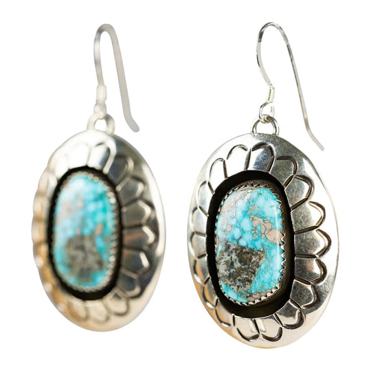 Silver earrings with turquoise stones on a white background