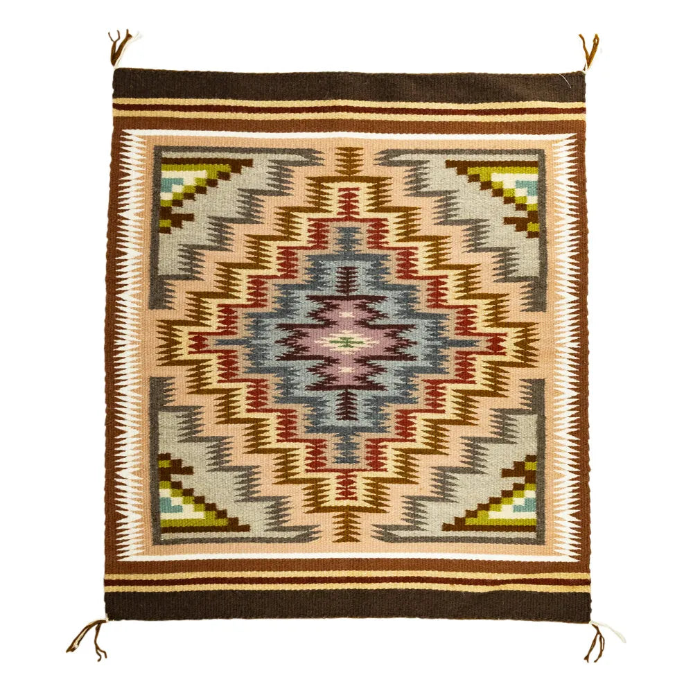 Handcrafted woven Navajo textile with geometric Burntwater pattern on a plain background