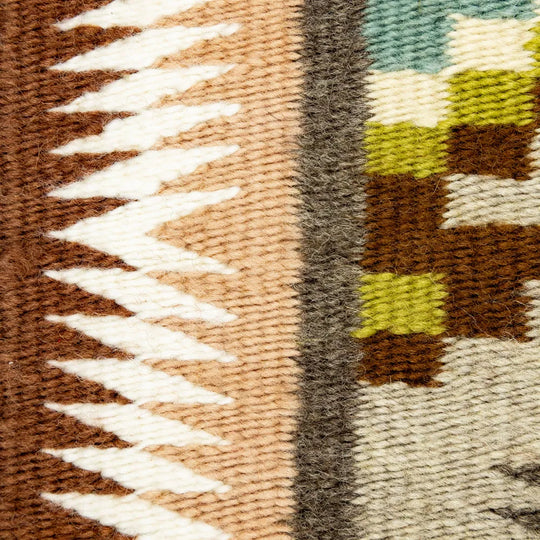 Close-up of a textured fabric with geometric pattern in earthy tones.