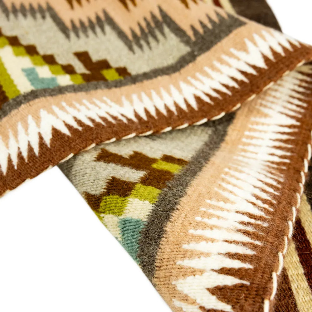 Close-up of a patterned fabric with geometric design on a white background