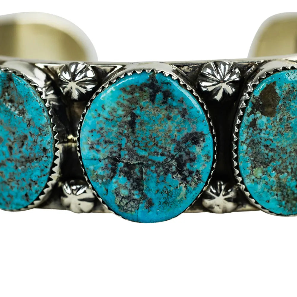 Turquoise stone bracelet with silver detailing on a white background