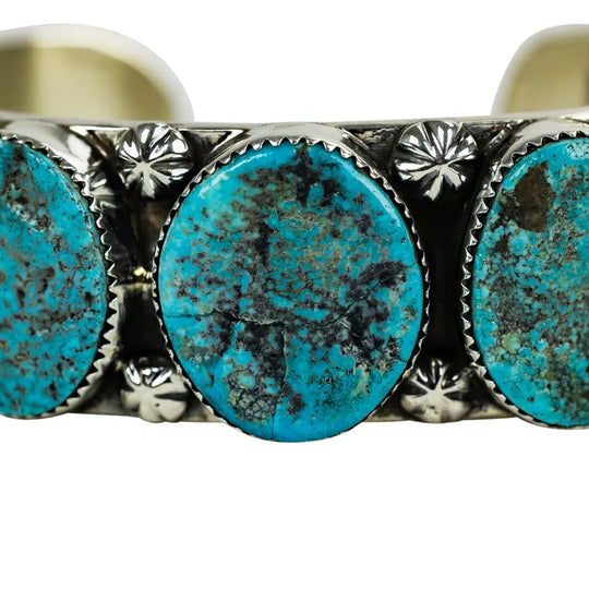Turquoise stone bracelet with silver detailing on a white background