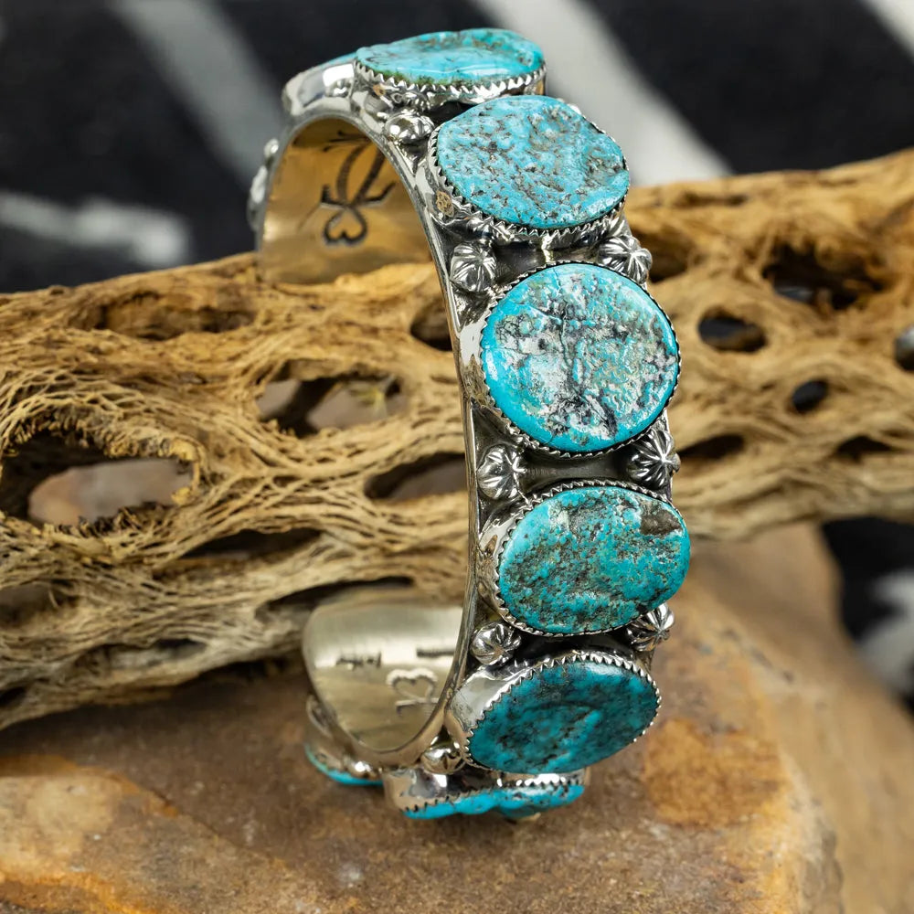Turquoise stone bracelet on a natural wood background