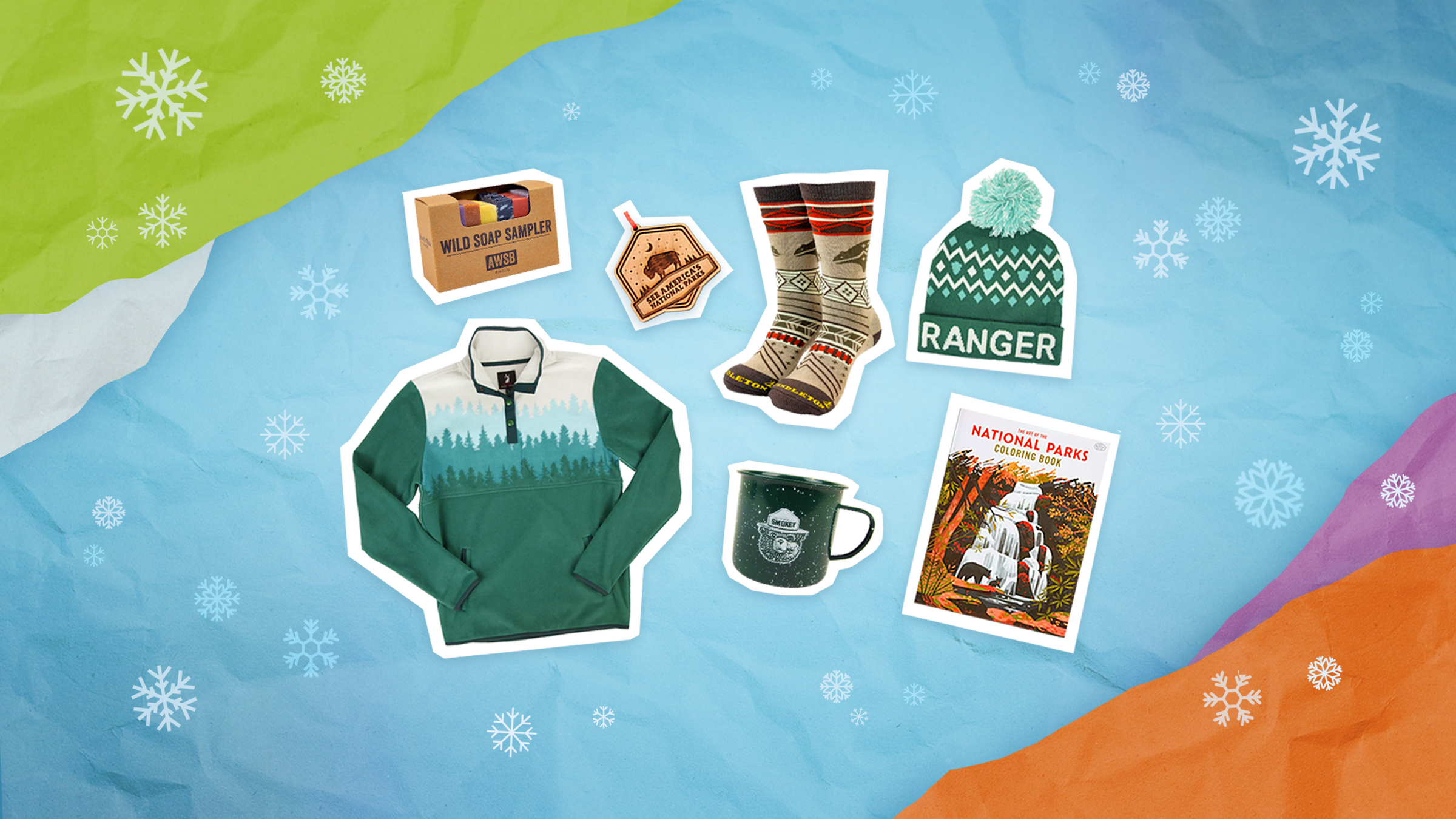 Set of winter-themed products including a sweater, mug, and card on a snowy background.