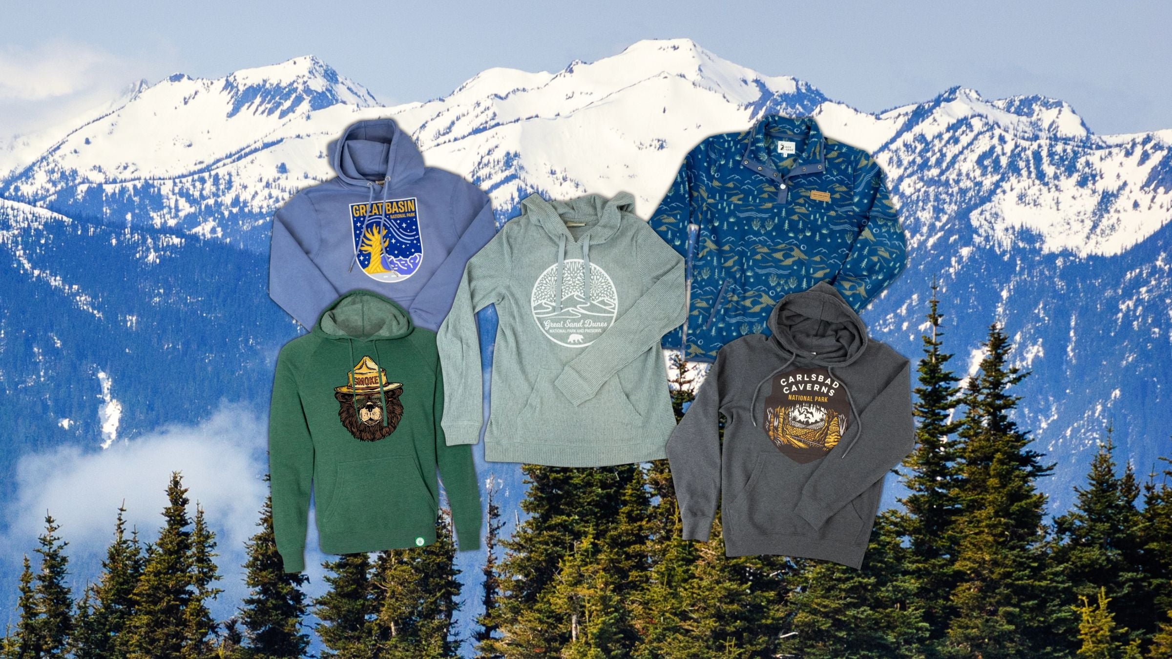Collection of hoodies with mountain and nature-themed designs against a mountainous background.