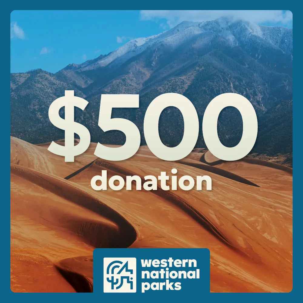 Desert landscape with mountains and '$500 donation' text overlay, featuring Western National Parks logo.