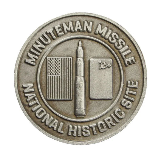 A collectible metal token with an image of the Minuteman Missile and the text 'MINUTEMAN MISSILE NATIONAL HISTORIC SITE'.